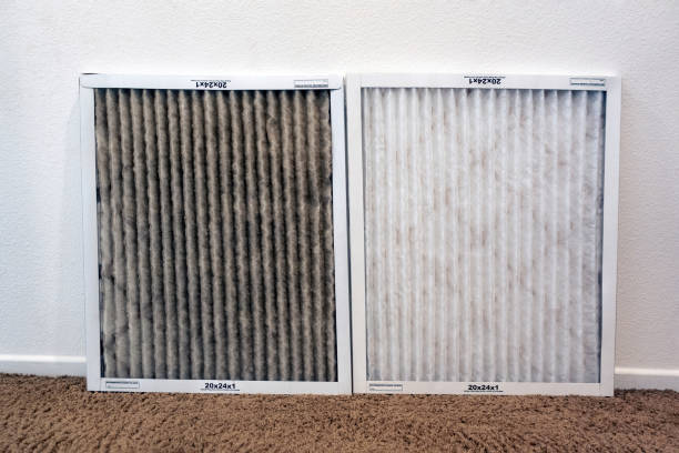 Dirty and clean AC furnace filters side by side to compare clogging levels.
